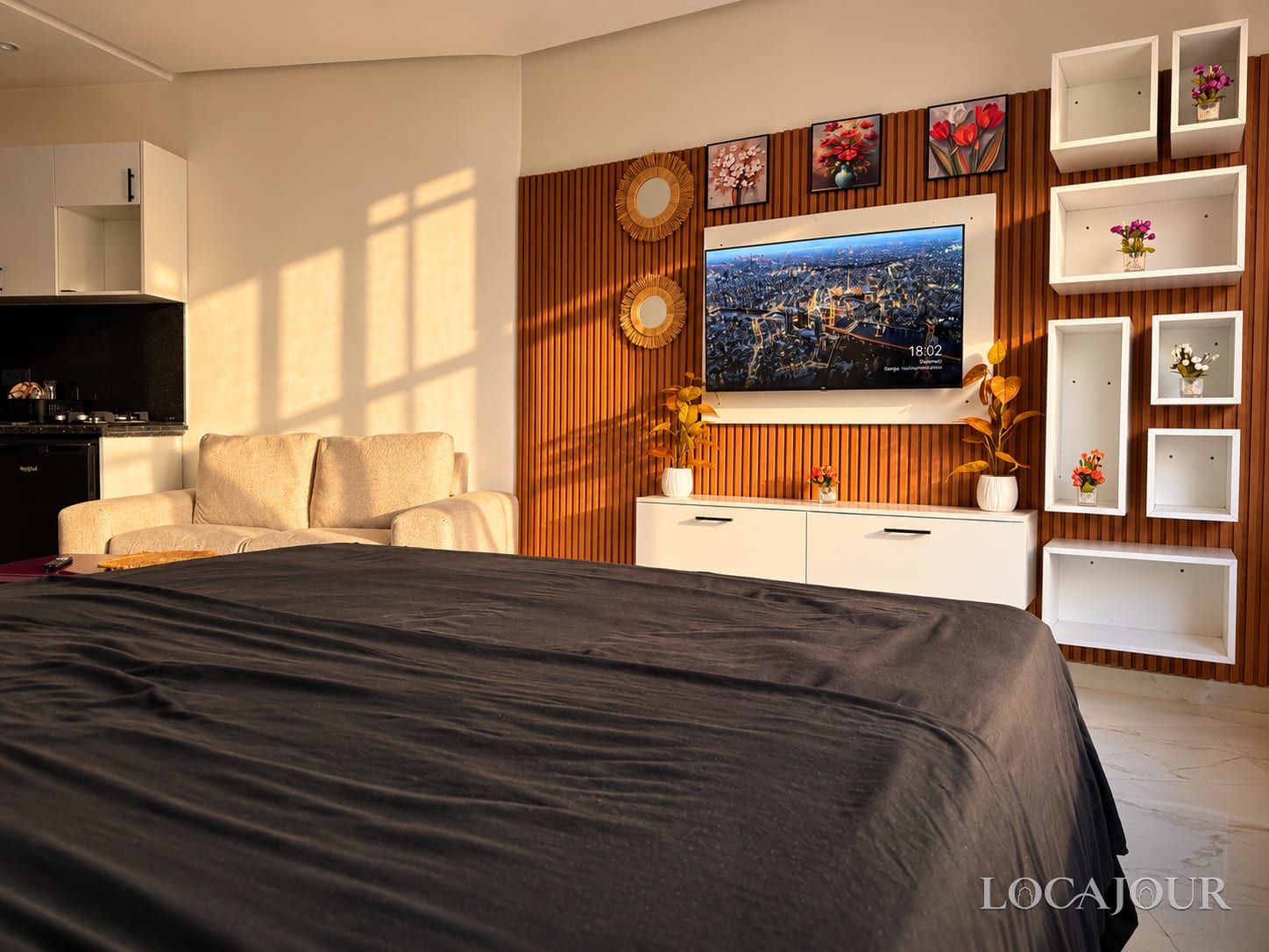 Modern luxury studio bedroom in Agdal Rabat with a comfortable bed, elegant decor and warm wood accents